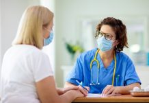 Doctor Examining Sick Patient. Ill Woman In Clinic