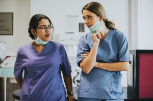 Nurses Having A Conversation In The Icu